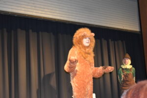 A teenager talking in a lion costume